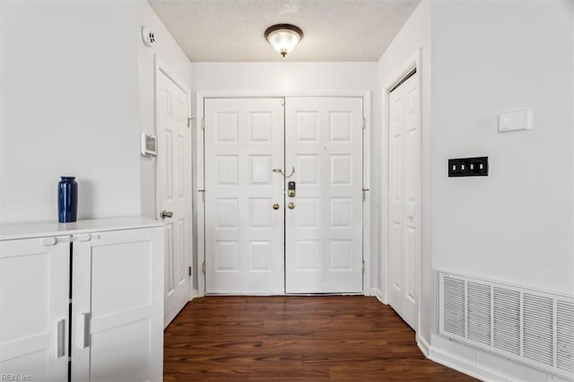 entryway featuring dark hardwood / wood-style floors and a textured ceiling