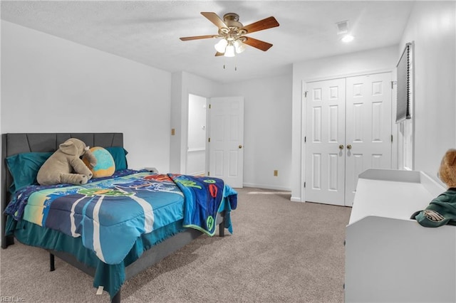 bedroom with carpet flooring, ceiling fan, and a closet