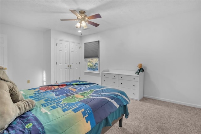 bedroom featuring light carpet, a closet, and ceiling fan