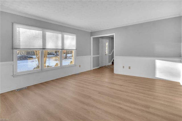 spare room with light hardwood / wood-style flooring and ornamental molding