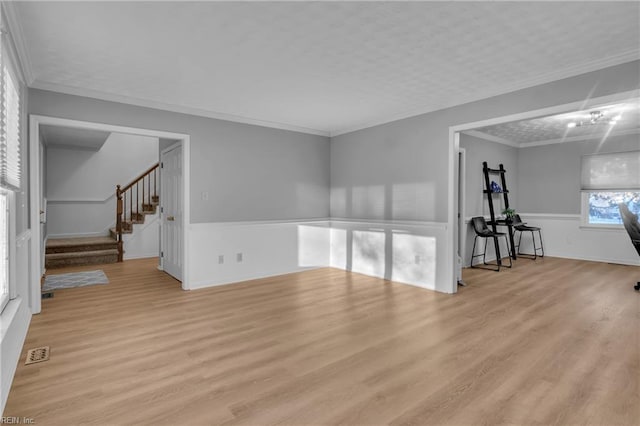 interior space featuring crown molding and light wood-type flooring