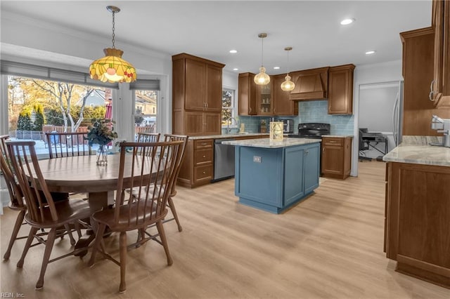 kitchen with crown molding, dishwasher, premium range hood, a center island, and decorative light fixtures