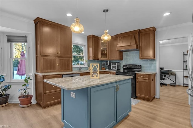 kitchen with custom exhaust hood, light stone counters, a center island, pendant lighting, and black range with electric stovetop