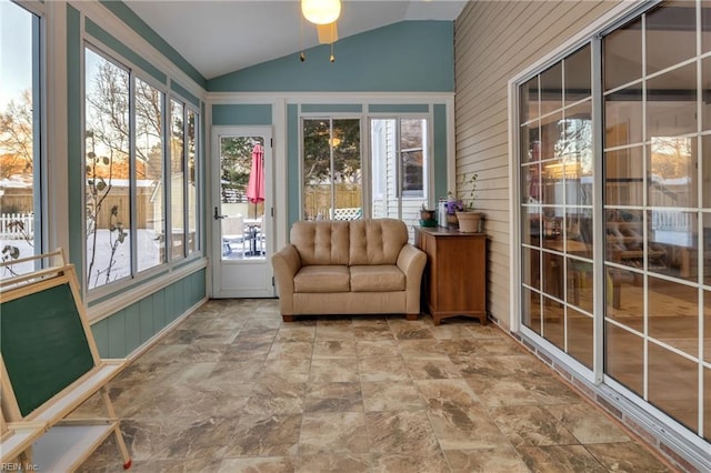 sunroom / solarium with ceiling fan and lofted ceiling