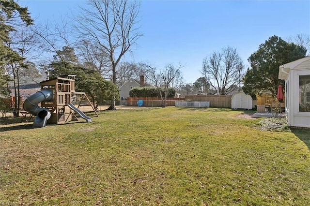 view of yard featuring a playground and a storage unit