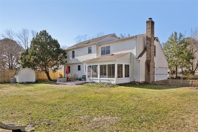 back of house with a patio, a yard, a shed, and a sunroom