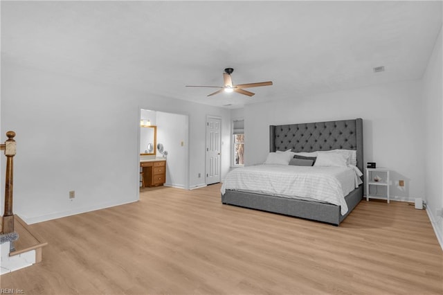 bedroom featuring ceiling fan, ensuite bath, and light hardwood / wood-style flooring