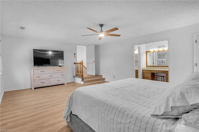 bedroom with connected bathroom, light hardwood / wood-style floors, and ceiling fan