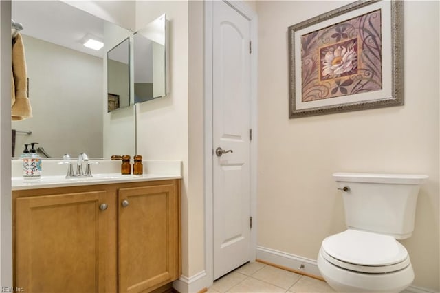 bathroom featuring toilet, vanity, and tile patterned flooring