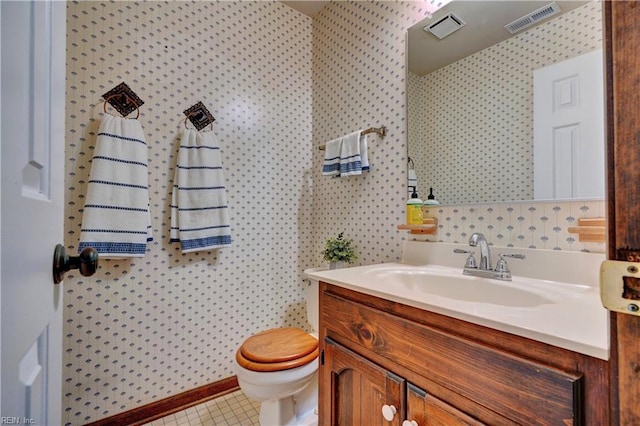 bathroom with vanity, toilet, and tile patterned floors