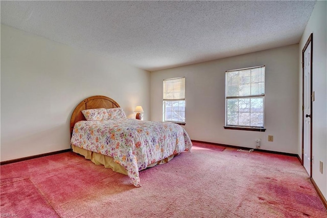 carpeted bedroom featuring a textured ceiling