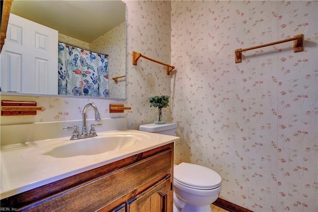 bathroom featuring toilet, vanity, and a shower with shower curtain