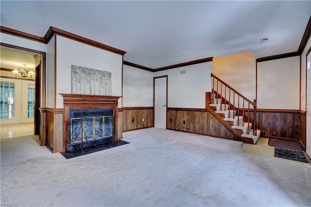 carpeted living room featuring crown molding and an inviting chandelier