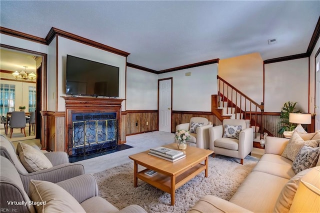 living room featuring light carpet, wooden walls, a notable chandelier, and ornamental molding