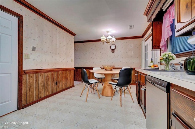 dining room with a chandelier and ornamental molding