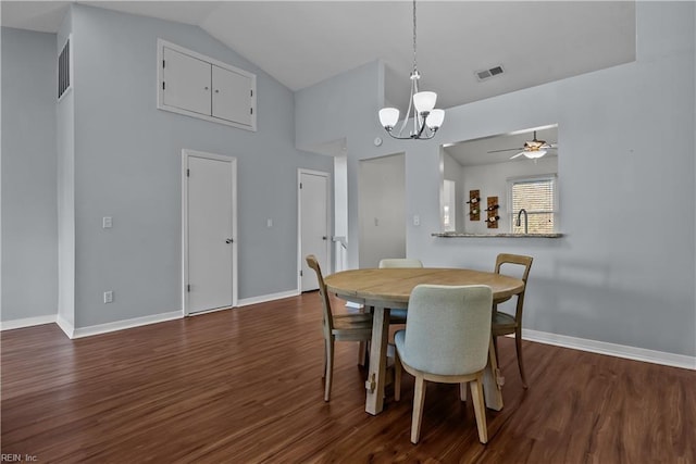 dining area with lofted ceiling, ceiling fan with notable chandelier, and dark hardwood / wood-style floors