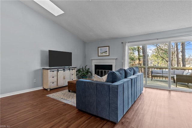 living room with dark wood-type flooring and lofted ceiling with skylight