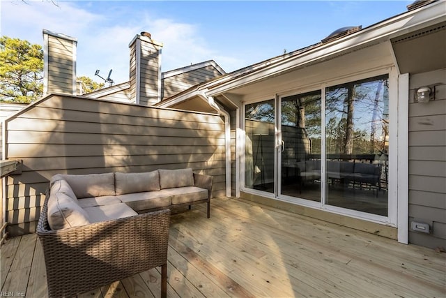 wooden terrace with an outdoor hangout area