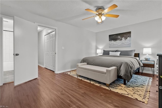 bedroom with ceiling fan, hardwood / wood-style floors, and a closet