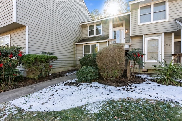 view of snow covered property entrance