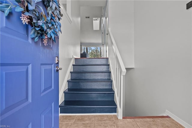 stairway featuring tile patterned floors