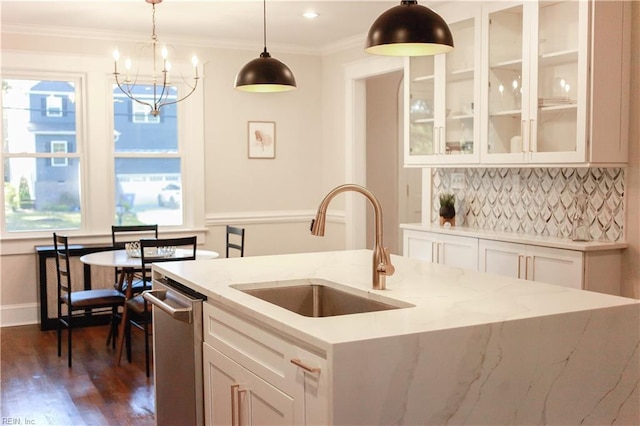 kitchen featuring decorative light fixtures, tasteful backsplash, white cabinetry, sink, and stainless steel dishwasher