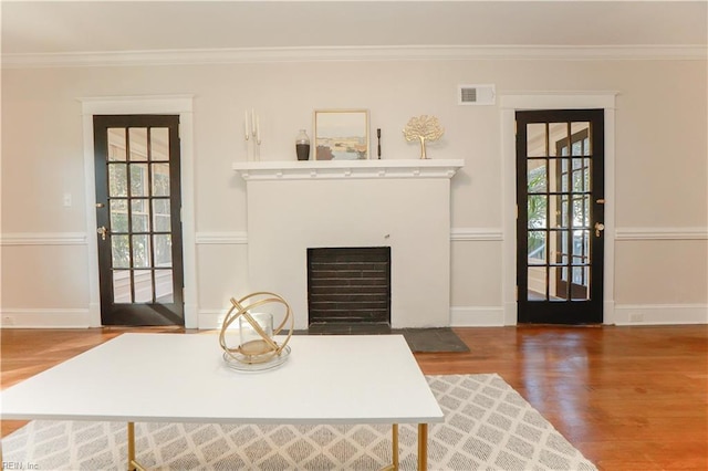 living room featuring crown molding and wood-type flooring