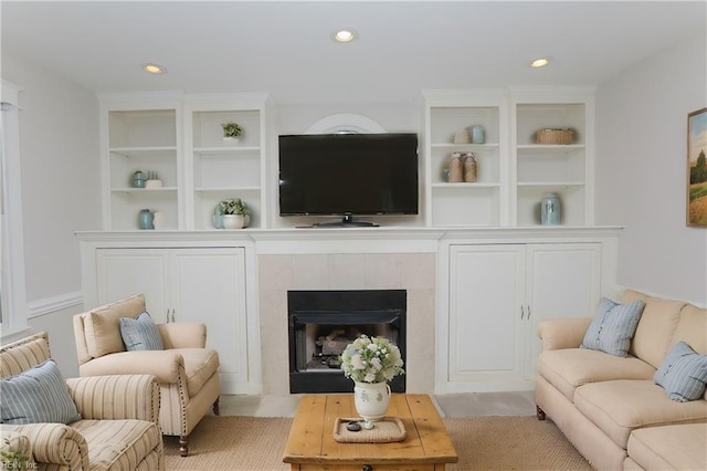 living room with a tiled fireplace