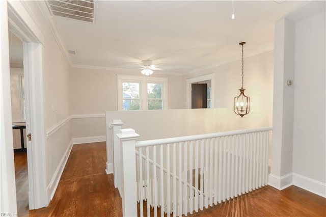 corridor featuring ornamental molding and dark hardwood / wood-style flooring