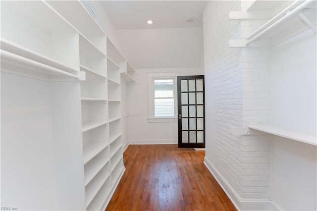 walk in closet with dark wood-type flooring