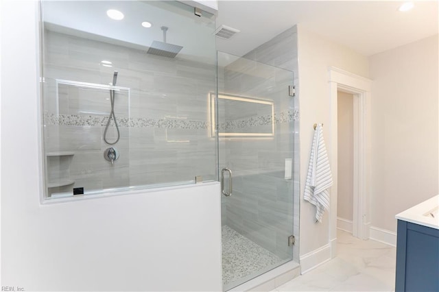 bathroom featuring vanity and a shower with shower door