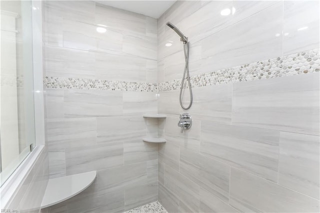 bathroom with tiled shower