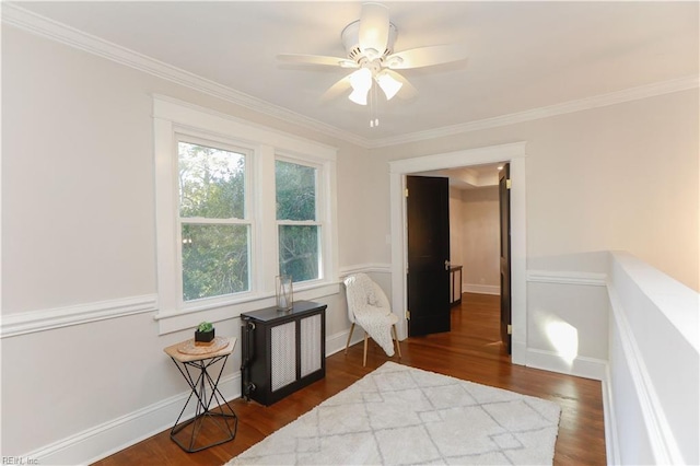 sitting room featuring ornamental molding, ceiling fan, and dark hardwood / wood-style flooring