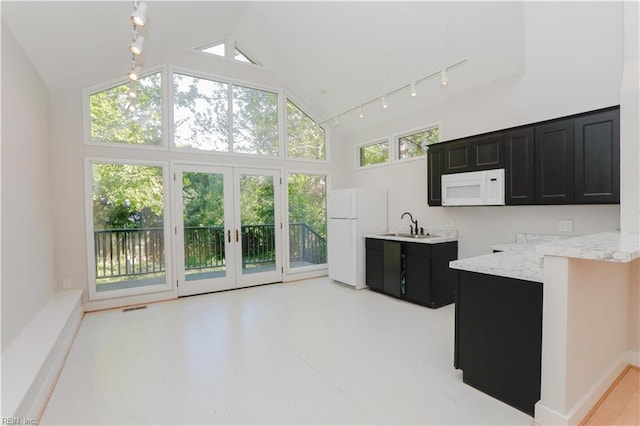 kitchen with french doors, sink, high vaulted ceiling, white appliances, and light stone countertops