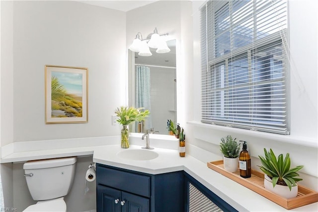 bathroom with vanity, a shower with curtain, and toilet