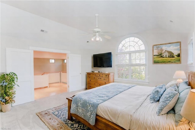 bedroom featuring lofted ceiling, light carpet, and ceiling fan