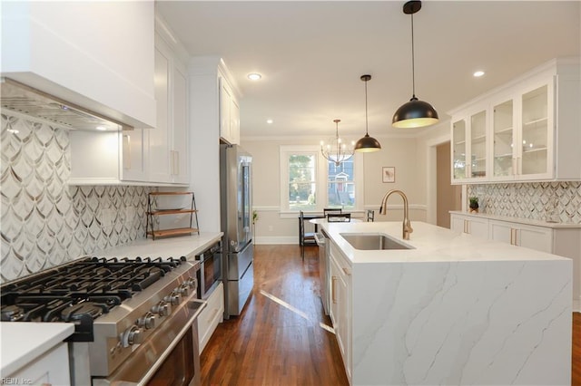 kitchen featuring high quality appliances, sink, custom exhaust hood, and white cabinets