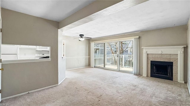 unfurnished living room featuring light carpet, a fireplace, and ceiling fan