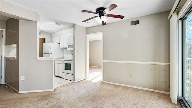 kitchen featuring ceiling fan, white appliances, light colored carpet, and white cabinets