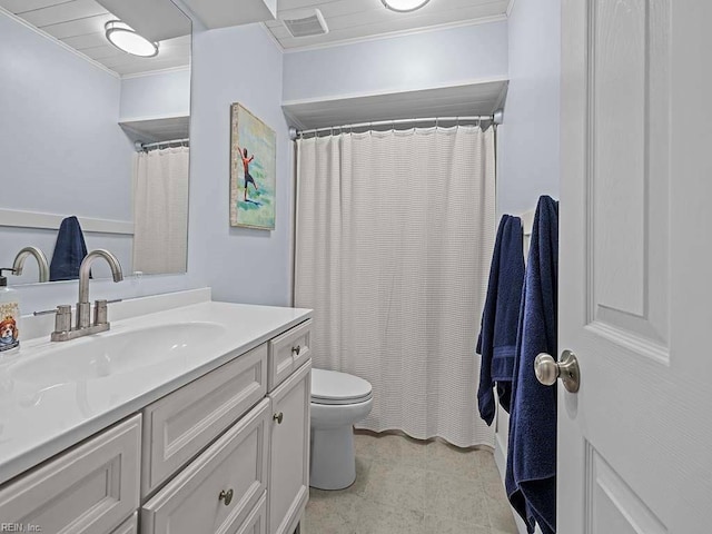 bathroom with vanity, toilet, and crown molding