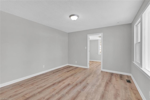 spare room featuring light hardwood / wood-style flooring