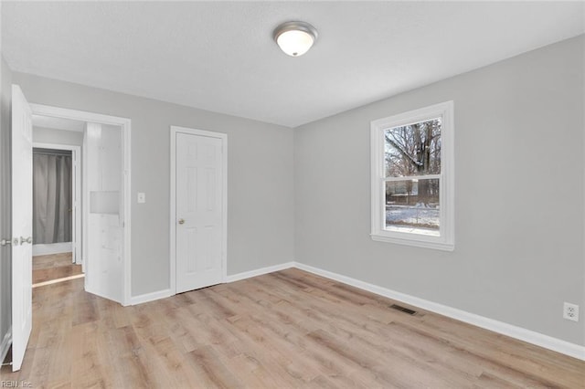 spare room featuring light hardwood / wood-style flooring