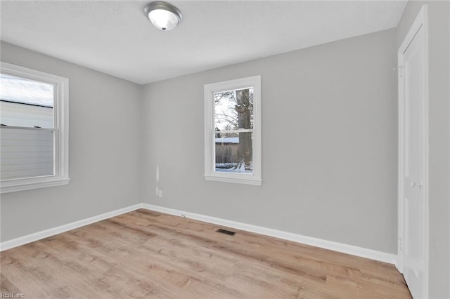 unfurnished room with light hardwood / wood-style flooring