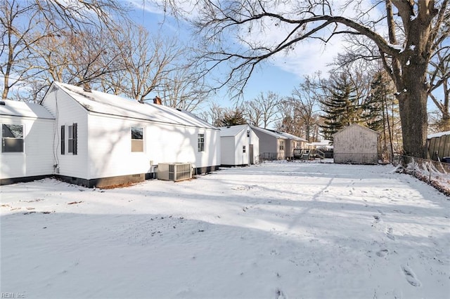 view of snowy exterior with central AC