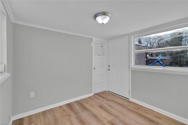 interior space with crown molding and light hardwood / wood-style flooring