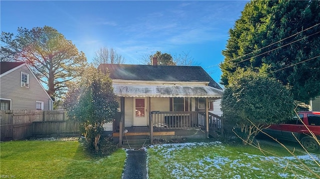 view of front of home with covered porch and a front yard