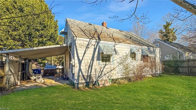 view of property exterior featuring a carport and a yard