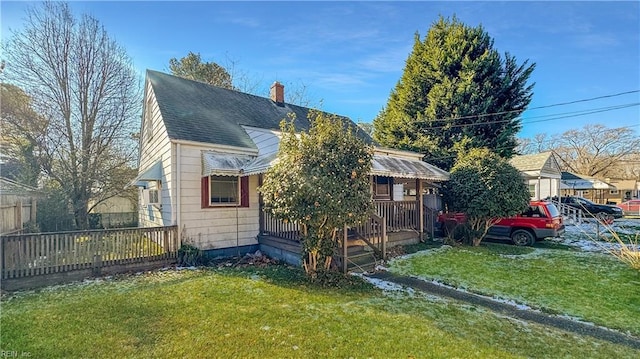 view of front of house with a porch and a front lawn