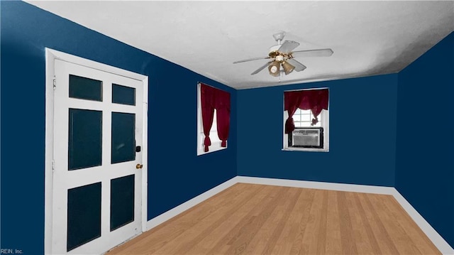 empty room with ceiling fan and wood-type flooring