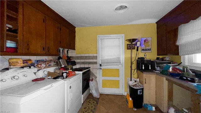 kitchen featuring washer and clothes dryer and white gas stove